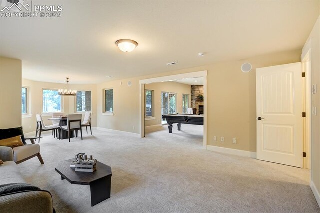 5085 Saxton Hollow Rd, Colorado Springs, CO 80908 - living room with billiards, light carpet, and a chandelier