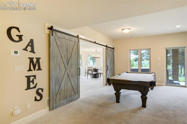5085 Saxton Hollow Rd, Colorado Springs, CO 80908 - game room with a barn door, light colored carpet, and healthy amount of natural light