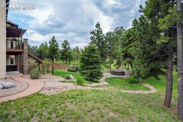 5085 Saxton Hollow Rd, Colorado Springs, CO 80908 - view of green lawn featuring a pergola, stairs, and a deck
