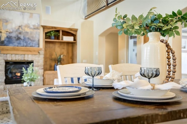 5085 Saxton Hollow Rd, Colorado Springs, CO 80908 - dining area with arched walkways and a fireplace