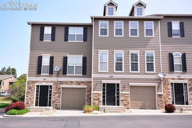 1160 Walters Pt, Monument, CO 80132 - view of property with an attached garage and stone siding