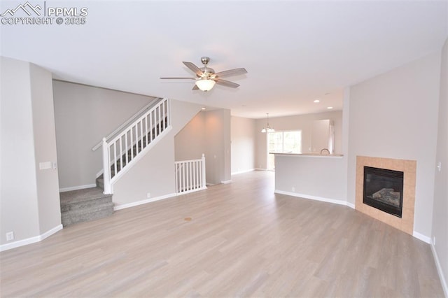 1160 Walters Pt, Monument, CO 80132 - unfurnished living room featuring light wood-type flooring, baseboards, a ceiling fan, stairway, and recessed lighting