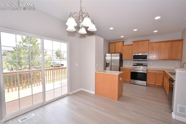 1160 Walters Pt, Monument, CO 80132 - kitchen with stainless steel appliances, a chandelier, light countertops, light wood-style floors, and baseboards