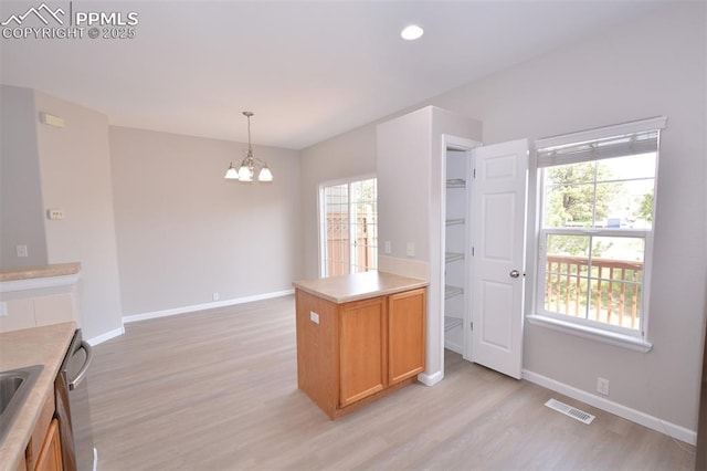 1160 Walters Pt, Monument, CO 80132 - kitchen featuring a chandelier, light wood finished floors, baseboards, decorative light fixtures, and light countertops