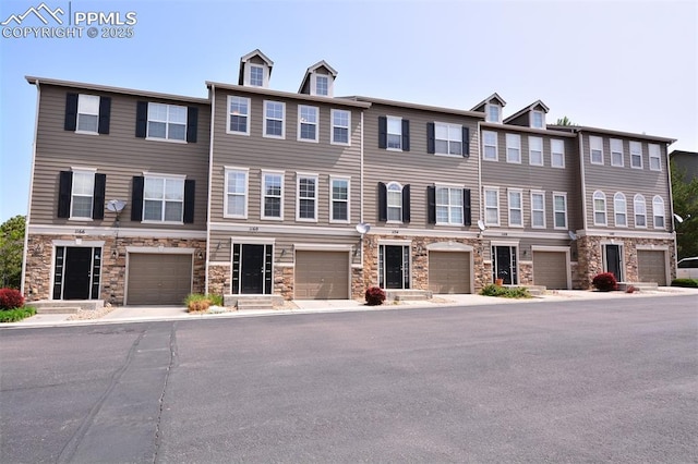 1160 Walters Pt, Monument, CO 80132 - multi unit property featuring stone siding and an attached garage