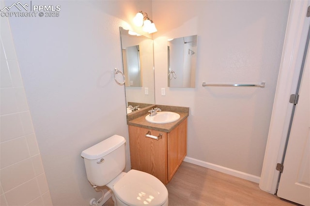 1160 Walters Pt, Monument, CO 80132 - bathroom featuring toilet, vanity, wood finished floors, and baseboards