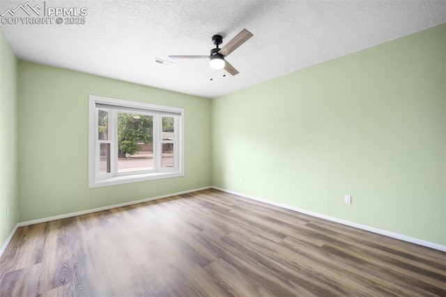305 Rosewood Dr, Fountain, CO 80817 - spare room with wood finished floors, ceiling fan, baseboards, and a textured ceiling