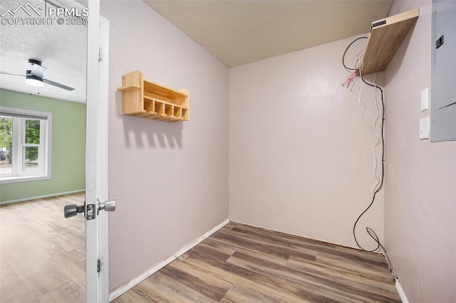 305 Rosewood Dr, Fountain, CO 80817 - laundry area with wood finished floors, a ceiling fan, and baseboards