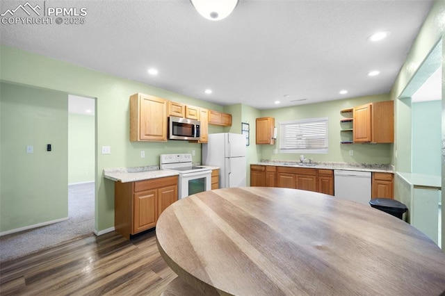 305 Rosewood Dr, Fountain, CO 80817 - kitchen with white appliances, a sink, dark wood-type flooring, light countertops, and recessed lighting