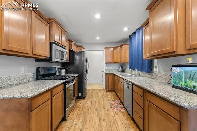 1513 Rosemont Dr, Colorado Springs, CO 80911 - kitchen with appliances with stainless steel finishes, a sink, light wood-type flooring, brown cabinetry, and recessed lighting