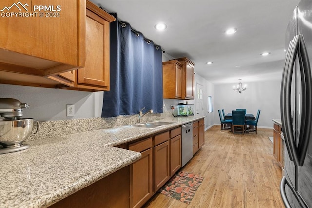 1513 Rosemont Dr, Colorado Springs, CO 80911 - kitchen with stainless steel appliances, a sink, brown cabinetry, light wood-style flooring, and recessed lighting