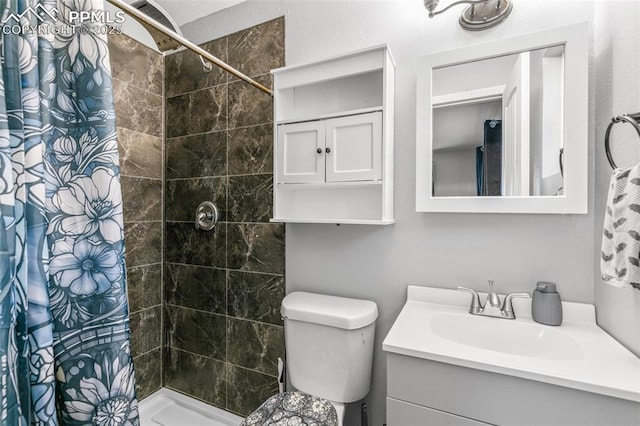 1513 Rosemont Dr, Colorado Springs, CO 80911 - bathroom featuring vanity, tiled shower, and toilet