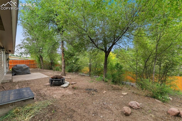 1513 Rosemont Dr, Colorado Springs, CO 80911 - fenced yard featuring a fire pit and a patio area