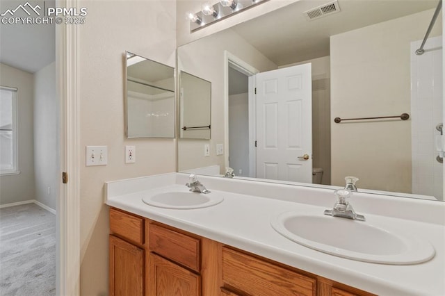 3730 Strawberry Field Grv Unit E, Colorado Springs, CO 80906 - full bath featuring double vanity, toilet, and a tile shower
