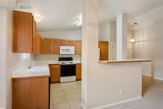 3730 Strawberry Field Grv Unit E, Colorado Springs, CO 80906 - kitchen with white appliances, a sink, tile countertops, light tile patterned floors, and lofted ceiling