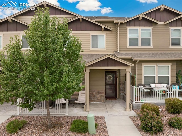 2001 Birmingham Loop, Colorado Springs, CO 80910 - view of front facade featuring board and batten siding, a porch, and roof with shingles