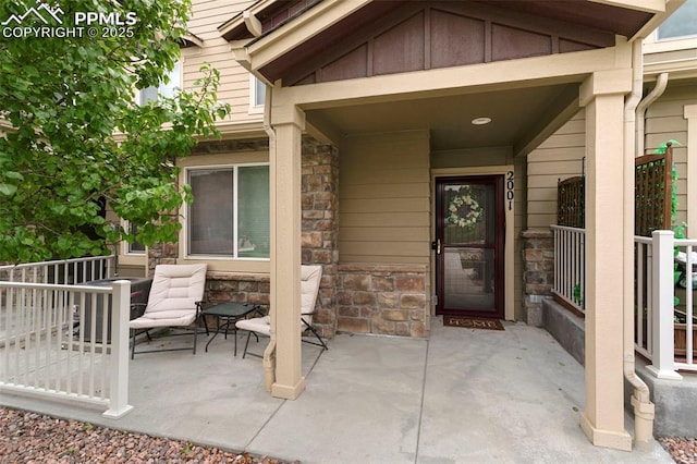 2001 Birmingham Loop, Colorado Springs, CO 80910 - entrance to property featuring stone siding, a patio, and board and batten siding