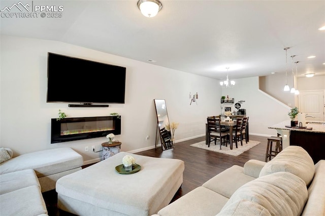 2001 Birmingham Loop, Colorado Springs, CO 80910 - living area featuring a chandelier, dark wood-style floors, baseboards, a glass covered fireplace, and recessed lighting