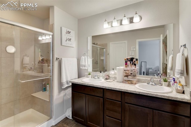 2001 Birmingham Loop, Colorado Springs, CO 80910 - full bath featuring a stall shower, double vanity, and tile patterned flooring