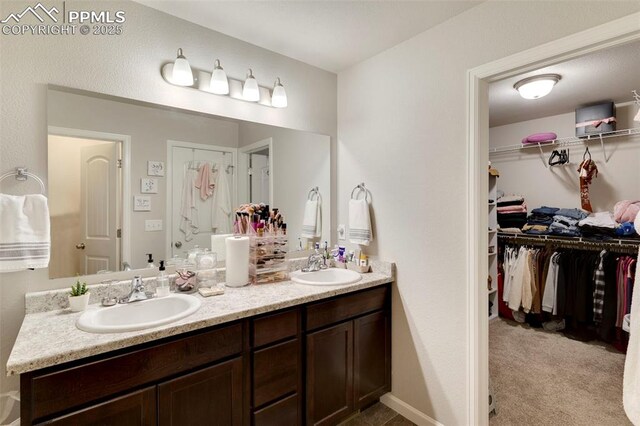 2001 Birmingham Loop, Colorado Springs, CO 80910 - bathroom featuring double vanity and a walk in closet