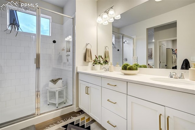 6950 Hidden Cove Ct, Castle Pines, CO 80108 - full bath featuring a stall shower, double vanity, and wood finished floors