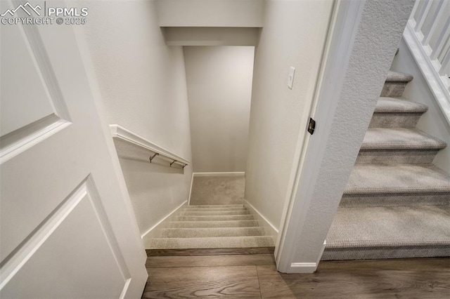 6950 Hidden Cove Ct, Castle Pines, CO 80108 - stairway with wood finished floors and baseboards