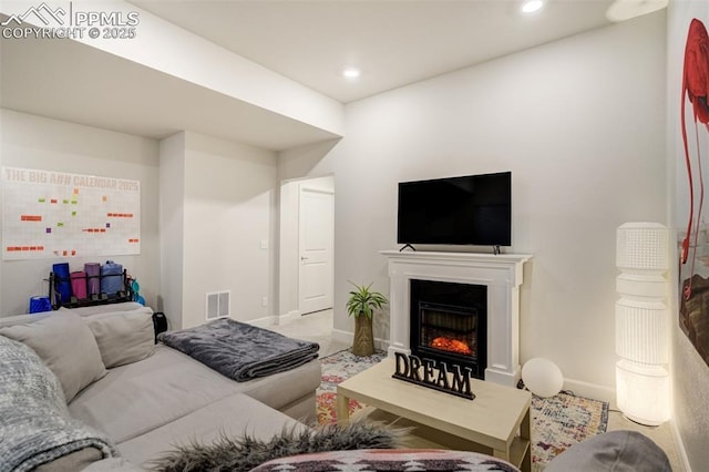 6950 Hidden Cove Ct, Castle Pines, CO 80108 - living area with a warm lit fireplace, baseboards, and recessed lighting