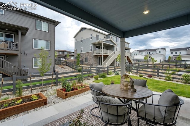 6950 Hidden Cove Ct, Castle Pines, CO 80108 - fenced backyard with a vegetable garden, stairs, a residential view, and a patio area