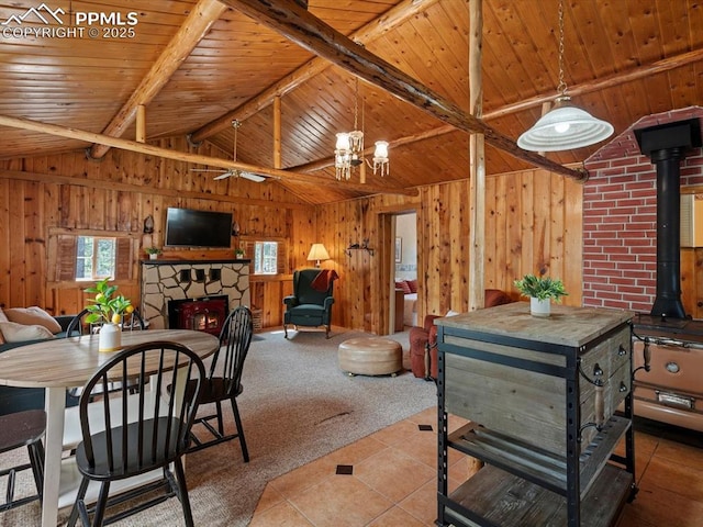 103 Alpine Rd, Woodland Park, CO 80863 - dining room featuring wooden ceiling, a fireplace, wooden walls, tile patterned floors, and a chandelier