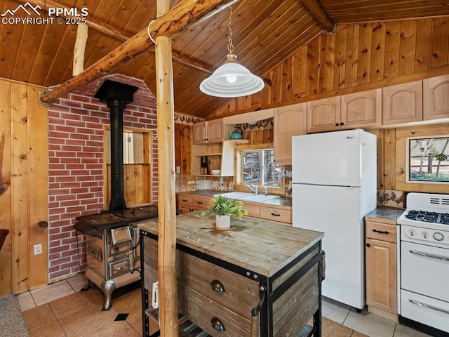 103 Alpine Rd, Woodland Park, CO 80863 - kitchen with white appliances, wooden walls, wood ceiling, a wood stove, and light tile patterned floors