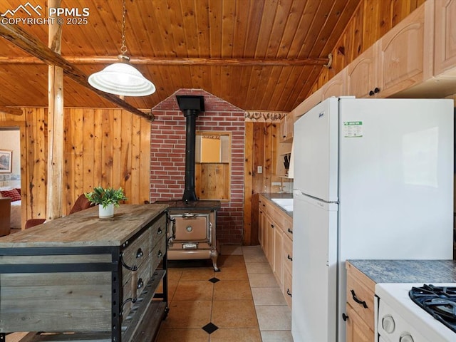 103 Alpine Rd, Woodland Park, CO 80863 - kitchen with wooden ceiling, a wood stove, freestanding refrigerator, light tile patterned floors, and light brown cabinetry
