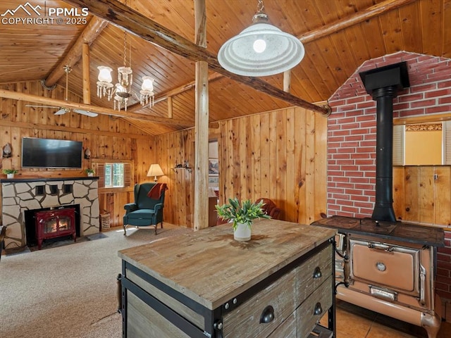 103 Alpine Rd, Woodland Park, CO 80863 - living room featuring a wood stove, wooden ceiling, a chandelier, wooden walls, and carpet floors