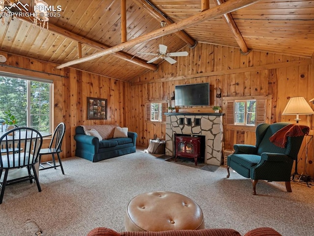 103 Alpine Rd, Woodland Park, CO 80863 - living area with healthy amount of natural light, carpet, wood ceiling, wood walls, and a wood stove