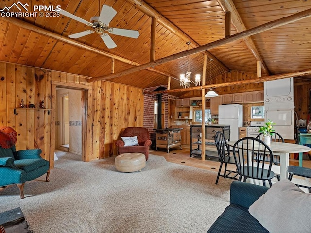 103 Alpine Rd, Woodland Park, CO 80863 - living area with wooden ceiling, wooden walls, a ceiling fan, a chandelier, and light carpet