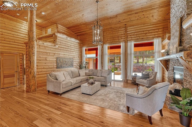 15975 Winding Trail Rd, Colorado Springs, CO 80908 - living room with high vaulted ceiling, a fireplace, log walls, wood ceiling, and wood-type flooring