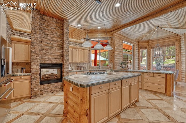 15975 Winding Trail Rd, Colorado Springs, CO 80908 - kitchen with inlaid floor details, light brown cabinetry, a center island, tile counters, and wooden ceiling