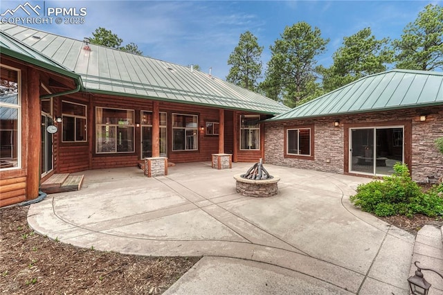 15975 Winding Trail Rd, Colorado Springs, CO 80908 - back of house featuring a standing seam roof, an outdoor fire pit, a metal roof, and a patio area