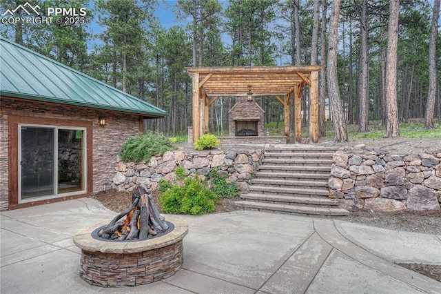15975 Winding Trail Rd, Colorado Springs, CO 80908 - view of patio / terrace featuring an outdoor fireplace and a fire pit