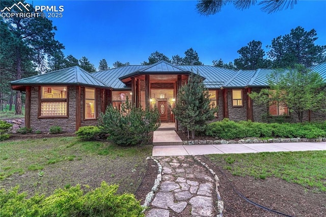 15975 Winding Trail Rd, Colorado Springs, CO 80908 - view of front of home featuring a standing seam roof, a metal roof, and stone siding