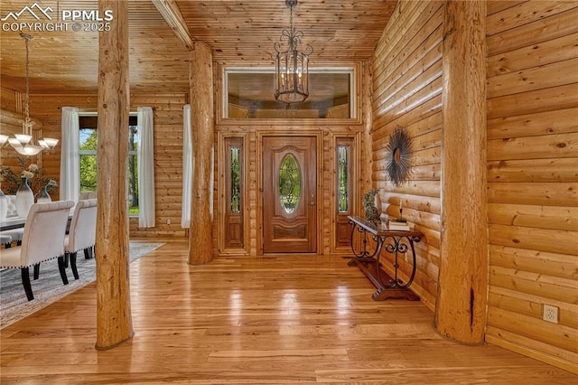 15975 Winding Trail Rd, Colorado Springs, CO 80908 - entryway featuring a chandelier, wood ceiling, log walls, and light wood-type flooring