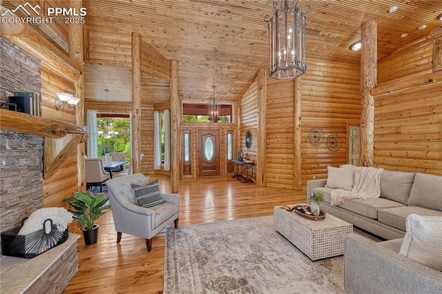 15975 Winding Trail Rd, Colorado Springs, CO 80908 - living area with high vaulted ceiling, log walls, wooden ceiling, a chandelier, and hardwood / wood-style flooring