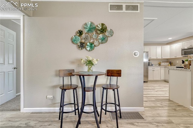 1917 S Institute Ave, Colorado Springs, CO 80905 - dining area featuring light wood-style flooring and a textured wall