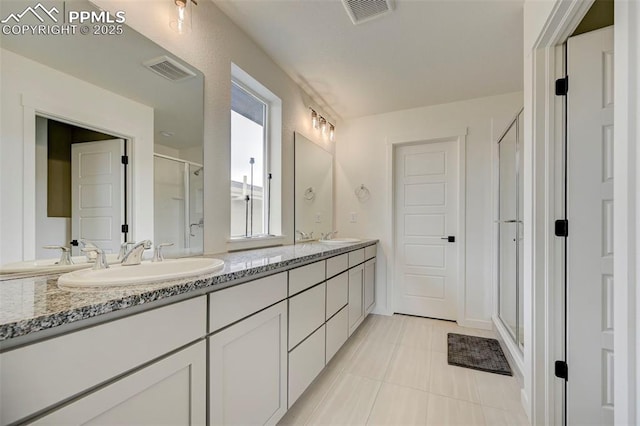 9276 Glitter Way, Colorado Springs, CO 80924 - full bath with a shower stall, double vanity, and tile patterned floors