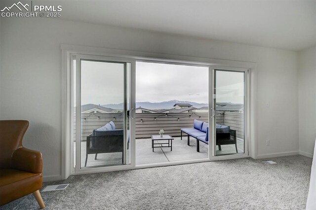 9276 Glitter Way, Colorado Springs, CO 80924 - living area featuring carpet floors, baseboards, and a mountain view