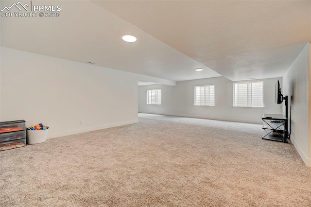 9276 Glitter Way, Colorado Springs, CO 80924 - unfurnished living room with carpet flooring, baseboards, and recessed lighting