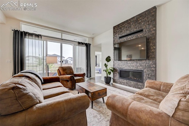9276 Glitter Way, Colorado Springs, CO 80924 - living area featuring a large fireplace and wood finished floors