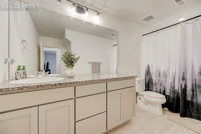 9276 Glitter Way, Colorado Springs, CO 80924 - full bathroom featuring toilet, vanity, and tile patterned flooring