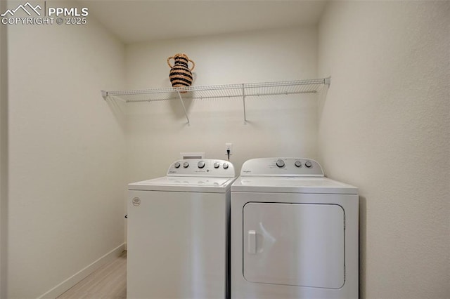 9276 Glitter Way, Colorado Springs, CO 80924 - washroom with washer and clothes dryer, baseboards, and light wood finished floors
