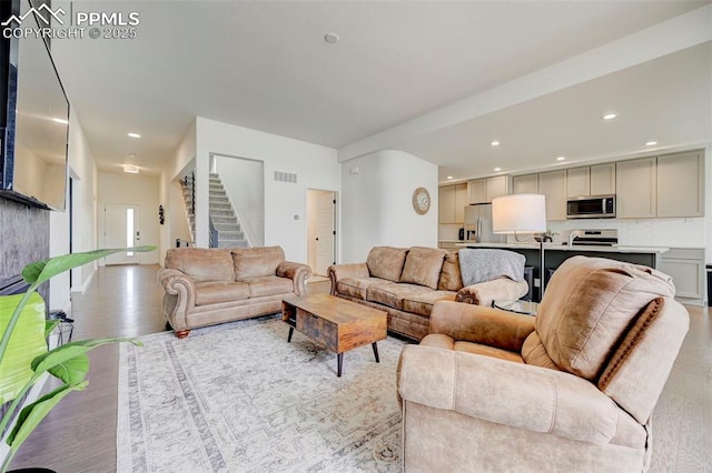 9276 Glitter Way, Colorado Springs, CO 80924 - living room with stairs, light wood-style flooring, and recessed lighting