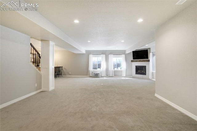 11598 Silver Charm Way, Colorado Springs, CO 80921 - unfurnished living room featuring carpet, a fireplace, recessed lighting, and stairway